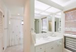 The master bathroom features two vanities with sinks, oversized soaking tub with shower, toilet, washer/dryer and closet